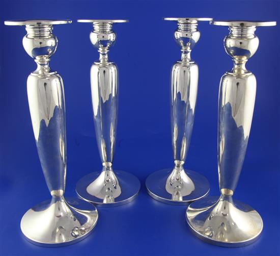 A set of four early 20th century American sterling silver candlesticks by Dominick & Haft, New York, weighted.